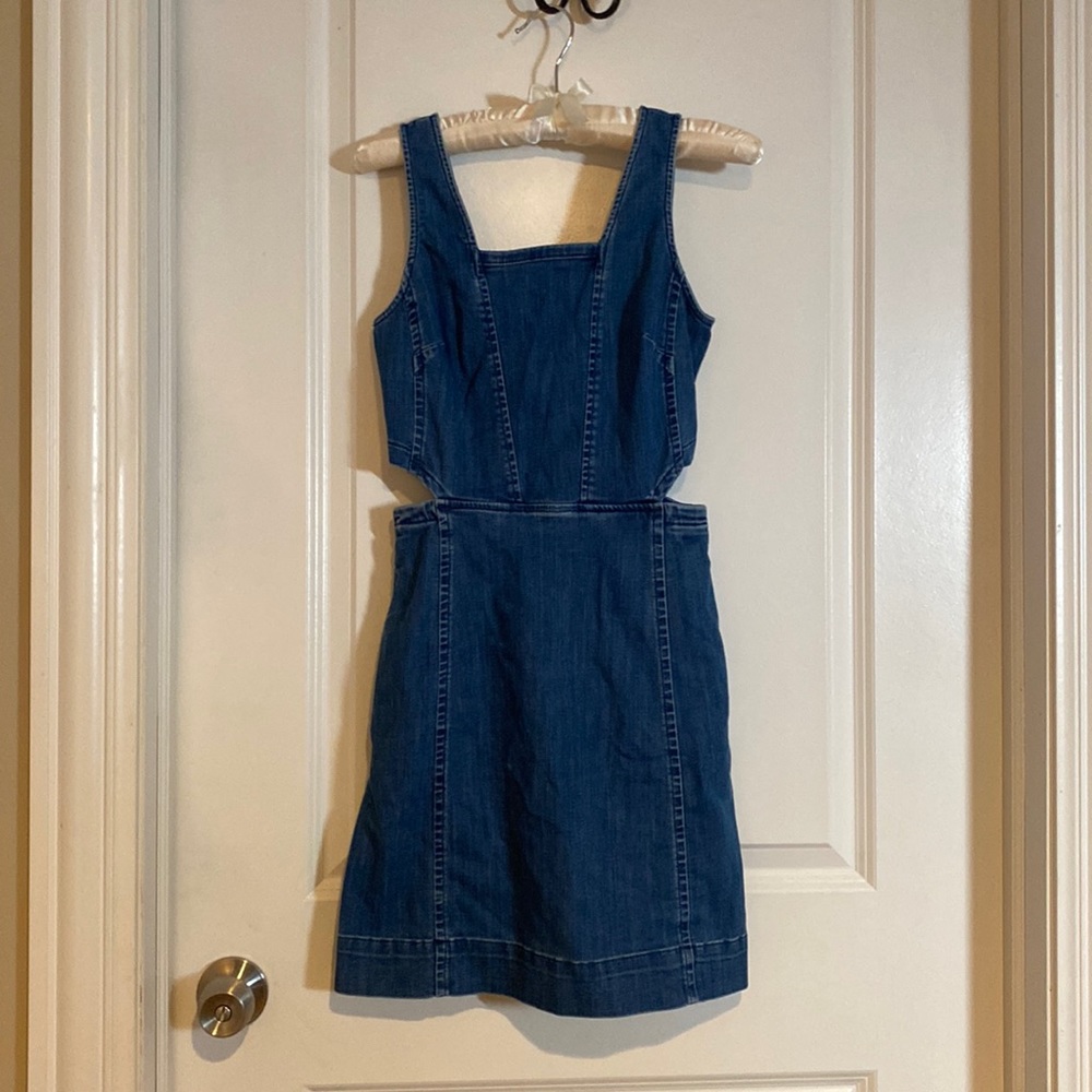 Jean dress, cut out on side and has pockets